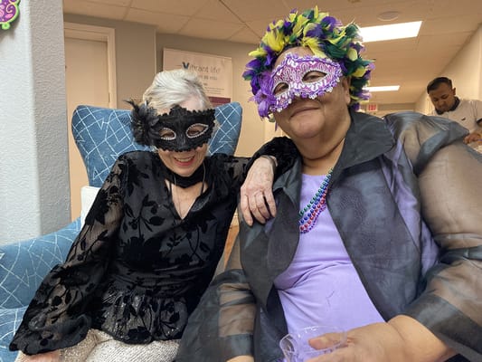Residents celebrating with masks at a festive event