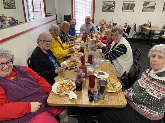 Residents enjoying a meal together at a dining table