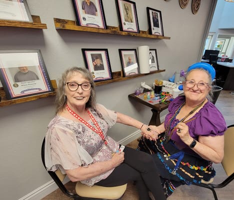 Two residents enjoying a crafting activity in a common area