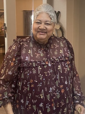 Smiling resident in a floral top