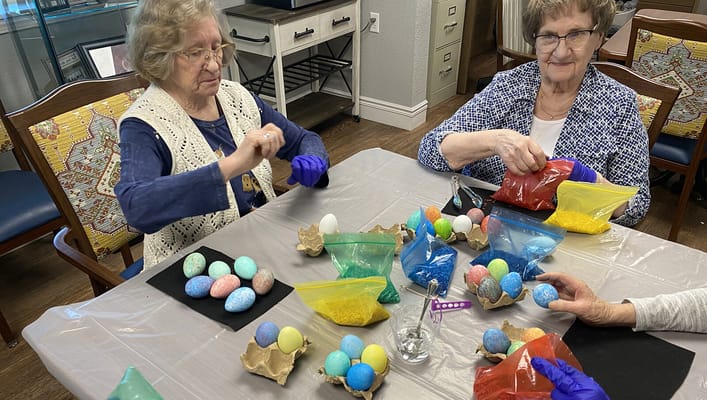 Residents participating in a crafting activity at a table