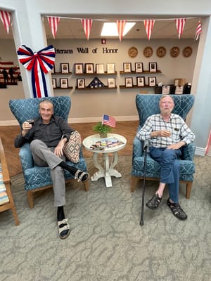 Two residents enjoying drinks in a common area