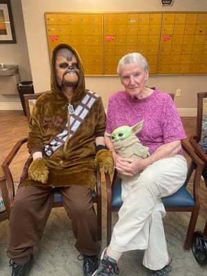 Residents dressed in costumes in a common area