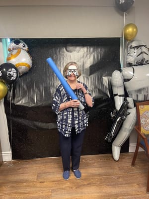 Resident enjoying a themed activity with props