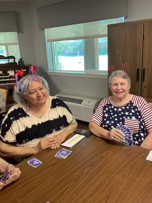 Two residents enjoying a card game in a common area