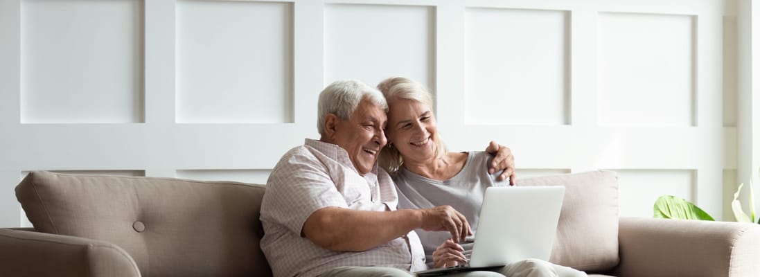 Senior couple enjoying time together on a laptop
