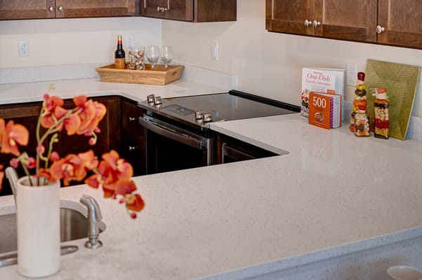 Modern kitchen with flowers and cooking books