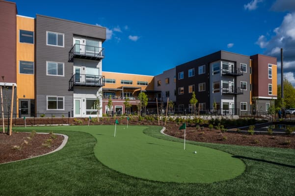 Well-maintained outdoor putting green area in a senior living facility