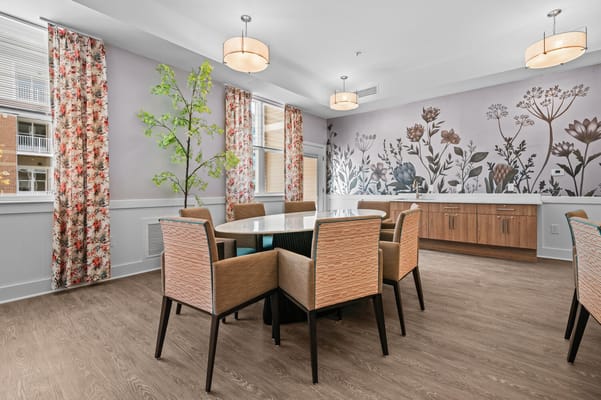 Bright common area with floral decor and dining table