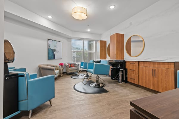 Beauty salon area with turquoise chairs and wooden cabinets