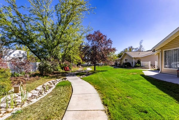 Pathway through landscaped outdoor area of assisted living facility