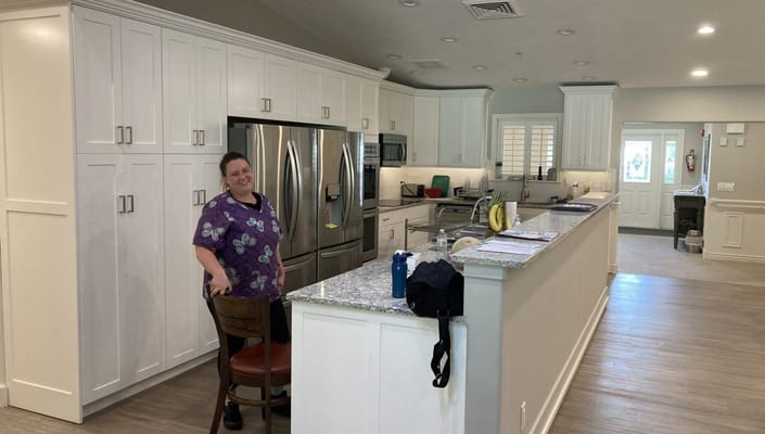 A staff member smiling in a modern kitchen