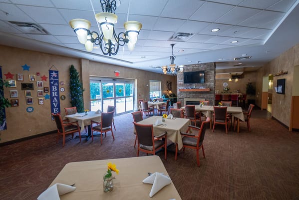 Dining area with tables and chairs set for meals