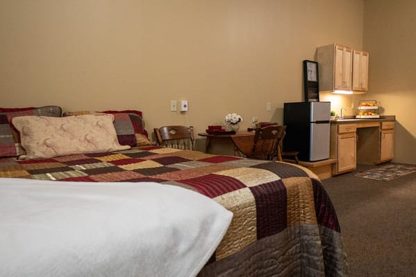 Cozy bedroom with kitchen area in a senior suite
