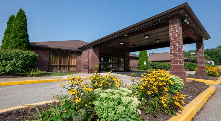 Exterior view with flowers at Loyalhanna Senior Suites