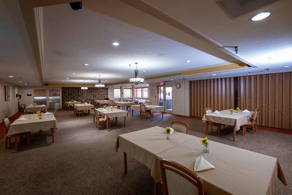Dining area with tables set for residents