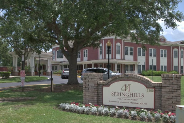 Entrance sign and building of Spring Hills Hunters Creek