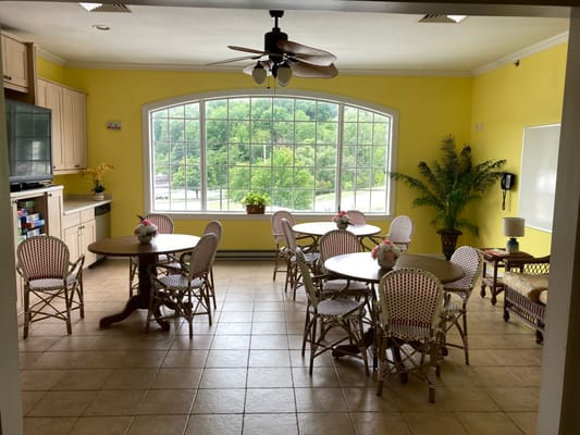 Bright common area with tables and seating arrangements
