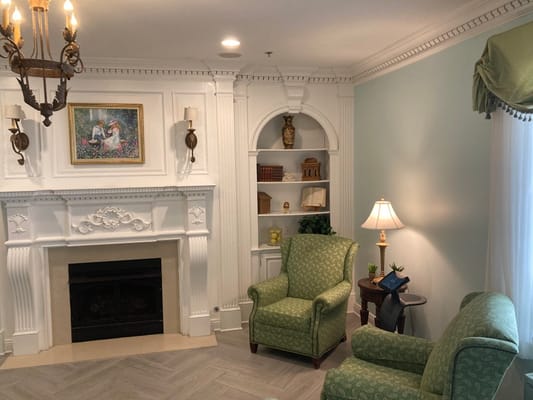 Cozy common area with green armchairs and decor