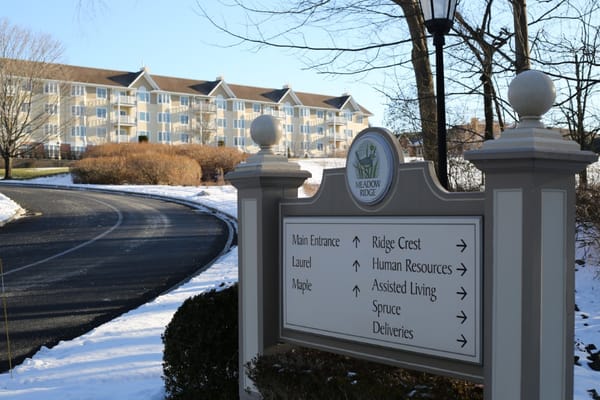 Sign directing to various facility locations in winter