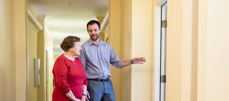 Staff member showing a resident around the hallway