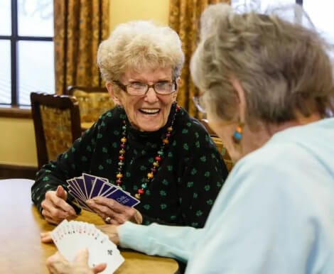 Residents enjoying a card game in a common area