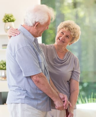 A senior couple smiling and enjoying each other's company indoors
