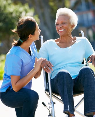 Caregiver interacting with a senior resident outdoors