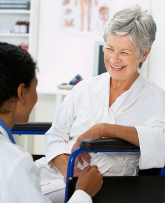A senior woman smiling during a consultation with staff