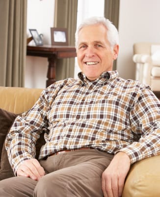 Smiling resident sitting comfortably in a living area