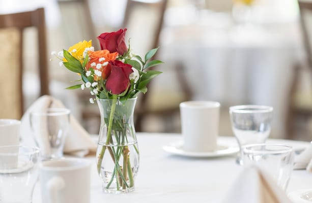 Floral centerpiece on a dining table in a social area