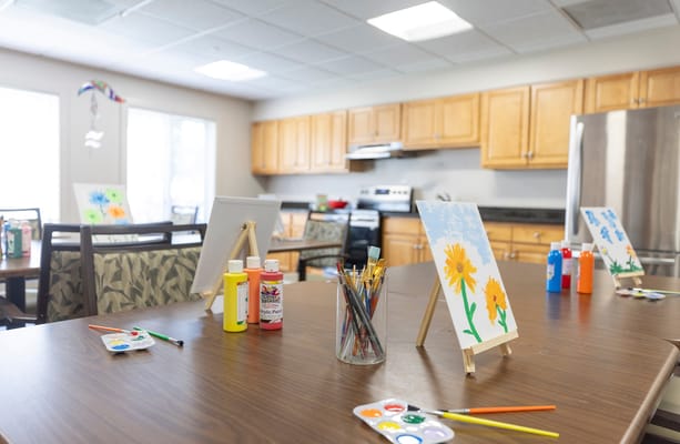 Art supplies and paintings on display in an activity room