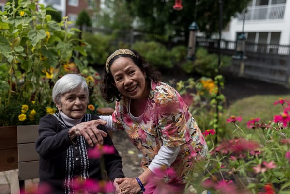 A resident and staff member enjoying a garden
