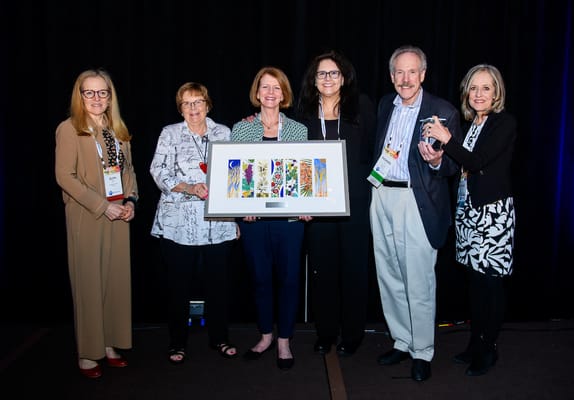 Group of people celebrating with an award