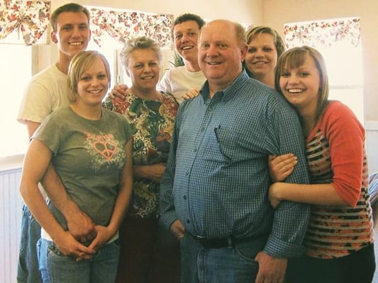 A group of smiling residents and their family members