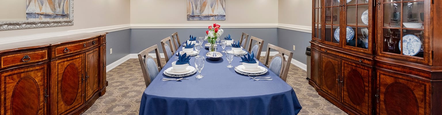 Dining room setup with blue table settings and floral centerpiece