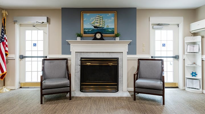 Lounge area with chairs and a fireplace