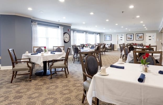 Bright and elegant dining room with tables set for meals