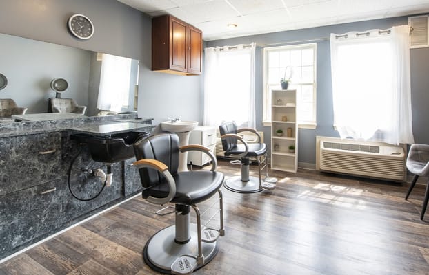 Bright and clean salon area with styling chairs