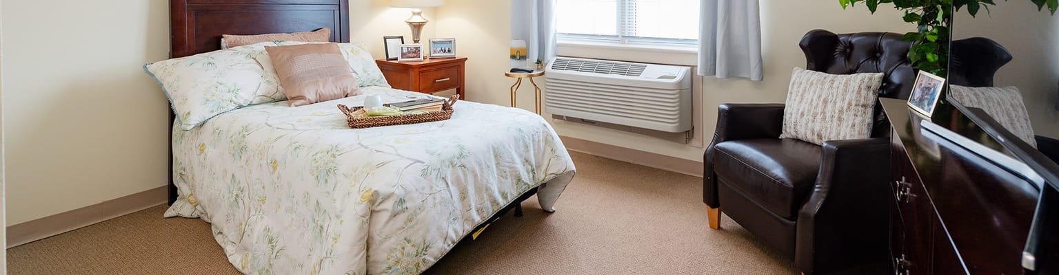 Cozy resident room with a bed and seating area