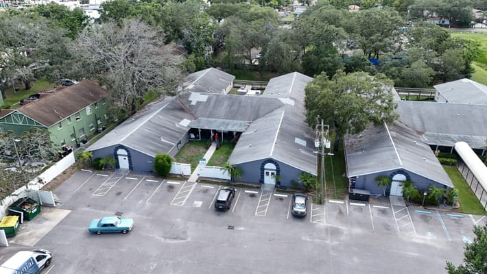Aerial view of Great American Assisted Living facility with surrounding trees and parking area.