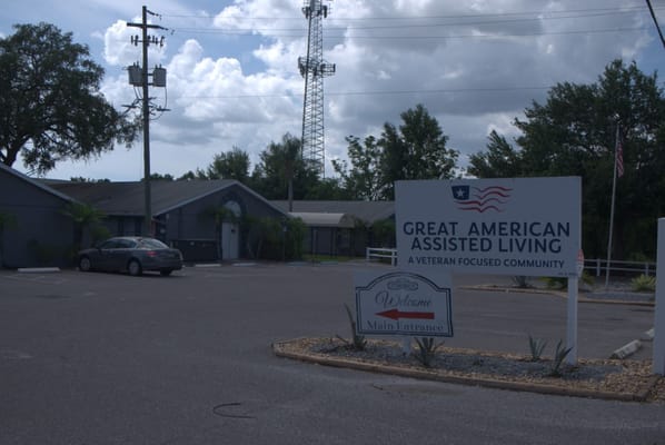 Signage for Great American Assisted Living and welcome sign at the entrance