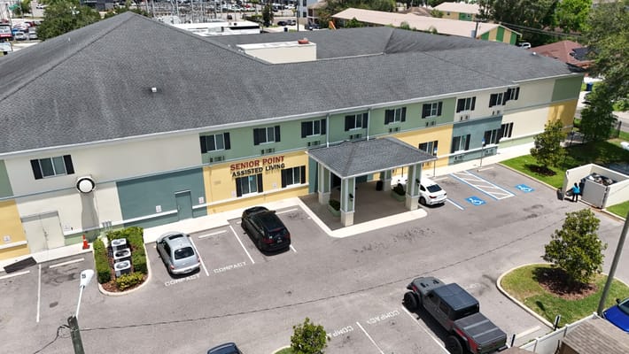 Aerial view of Senior Point Assisted Living facility with parking area.