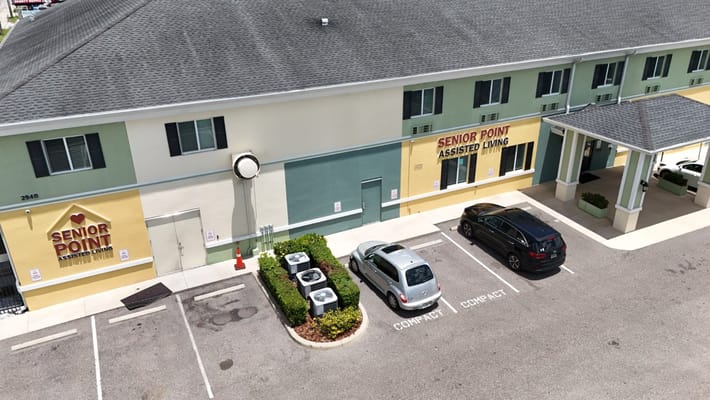 Exterior of Senior Point Assisted Living building with parking area