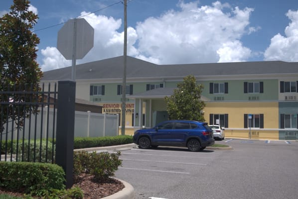Exterior of Senior Point Assisted Living facility with parking area