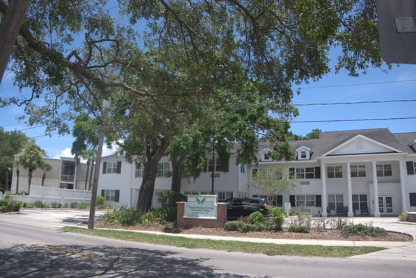 Exterior view of Angels Senior Living building with greenery
