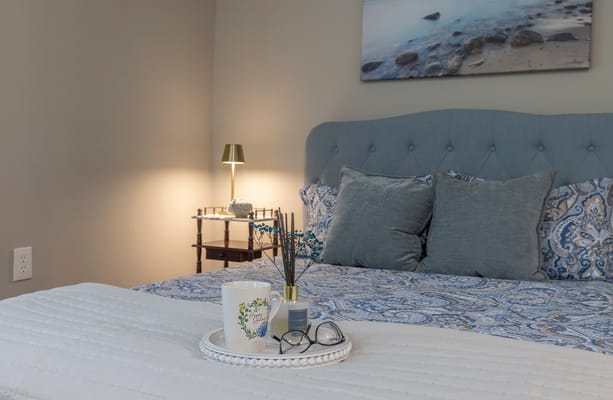 Cozy bedroom with bed, lamp, and decorative items