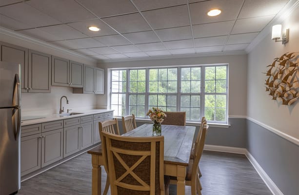 Bright dining area with windows overlooking greenery