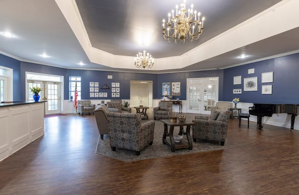Bright common area with comfortable seating and chandelier