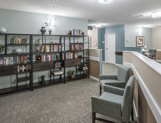 Interior view of a cozy library area with bookshelves and seating
